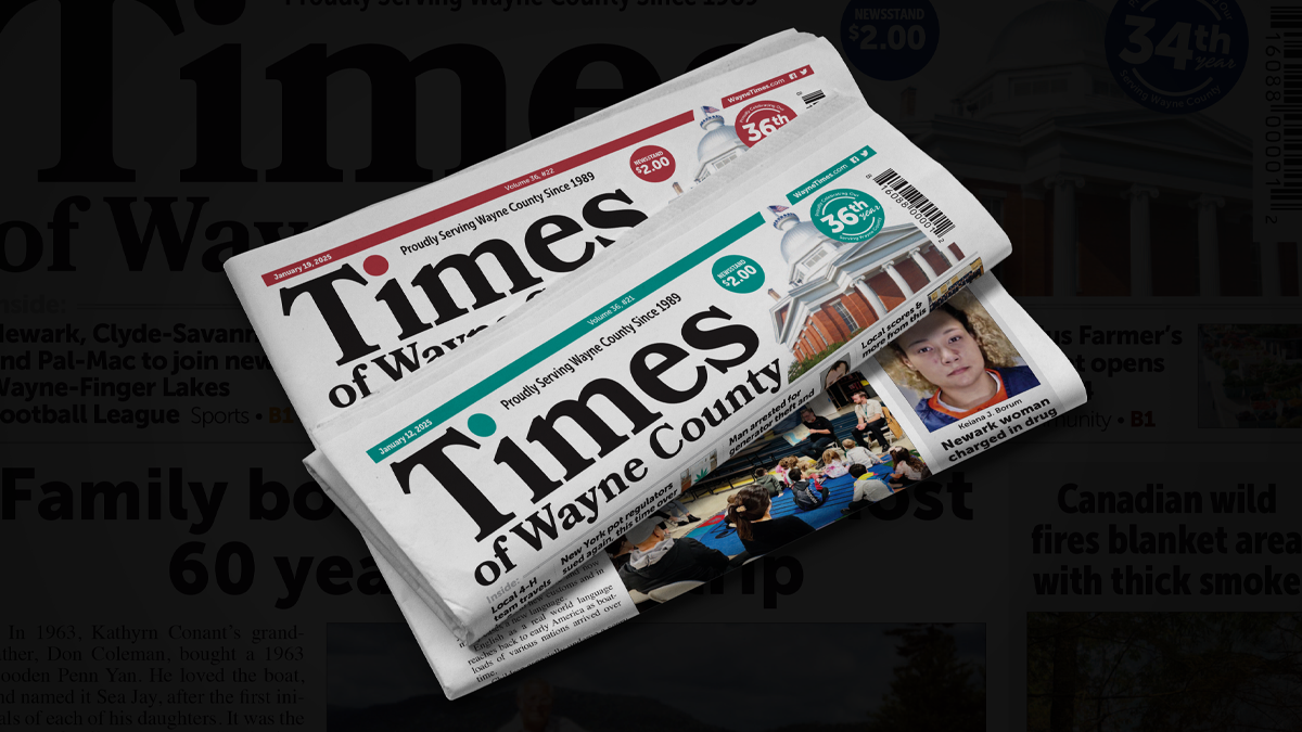 Stack of Times of Wayne County newspapers on a newsstand in upstate New York.